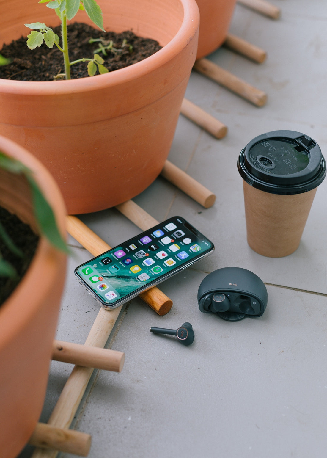 black iphone 5 beside black round ashtray
