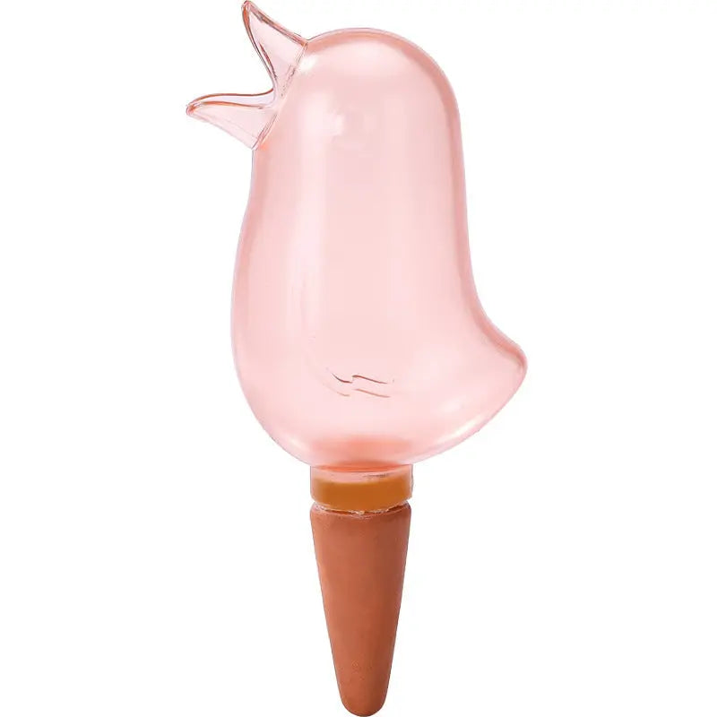 Pink glass bird-shaped self-watering spike for indoor garden plant care