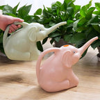 Baby elephant watering flowers - soilcommander