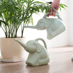 Baby elephant watering flowers - soilcommander