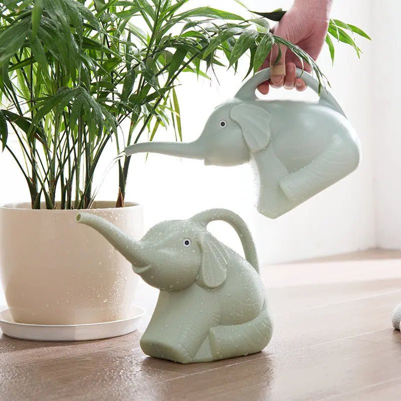 Baby elephant watering flowers - soilcommander
