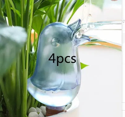Bird-shaped self-watering device for plants, set of 4, in indoor garden setting